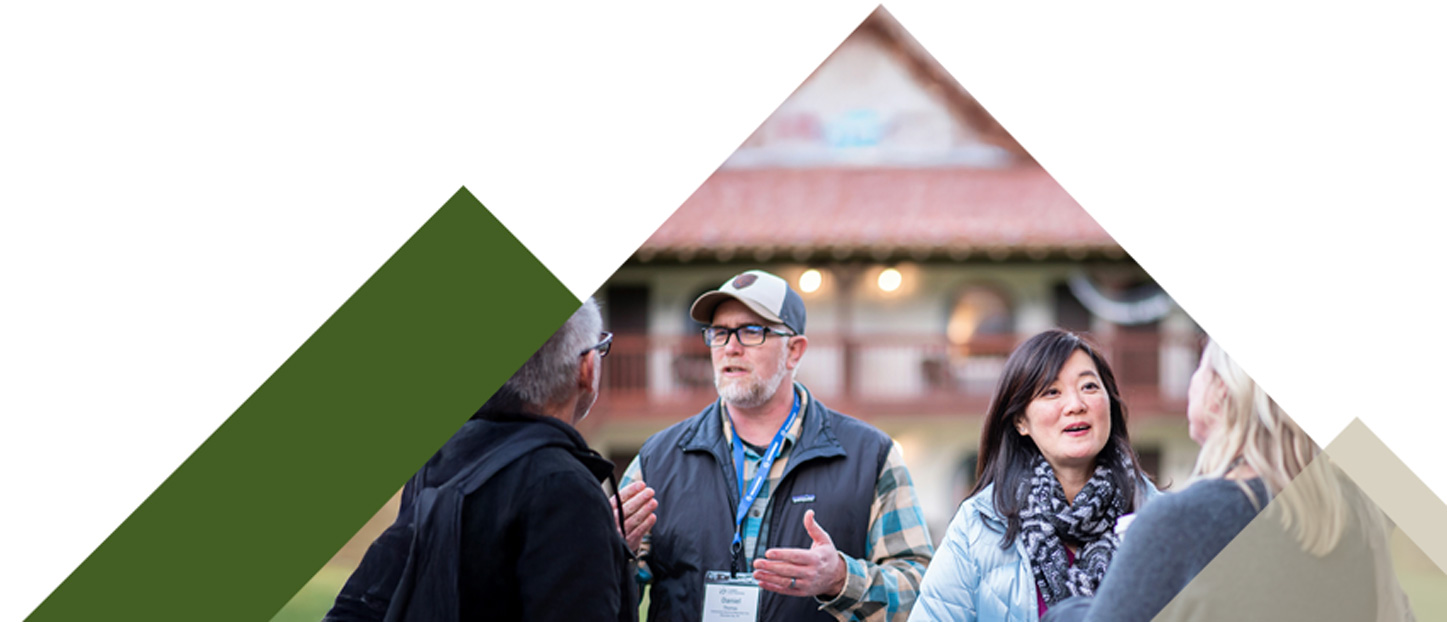 Group of people collaborating outside in front of a building