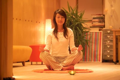meditation woman sits with eyes closed in meditation