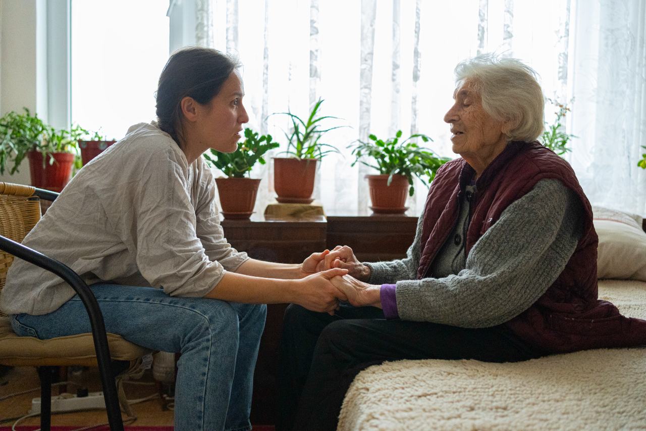connection woman holds hands with her elder