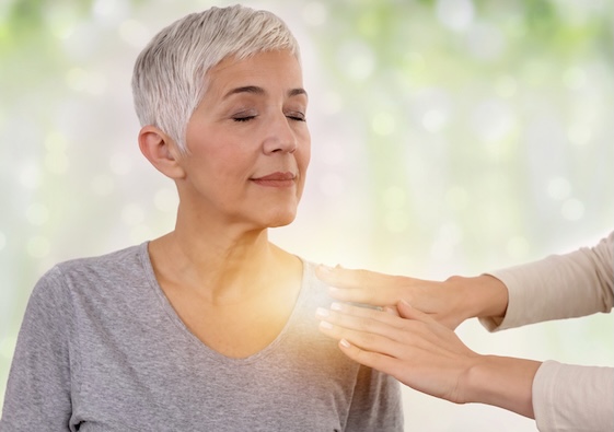 iStock-1132352015 (1) woman receiving reiki treatment