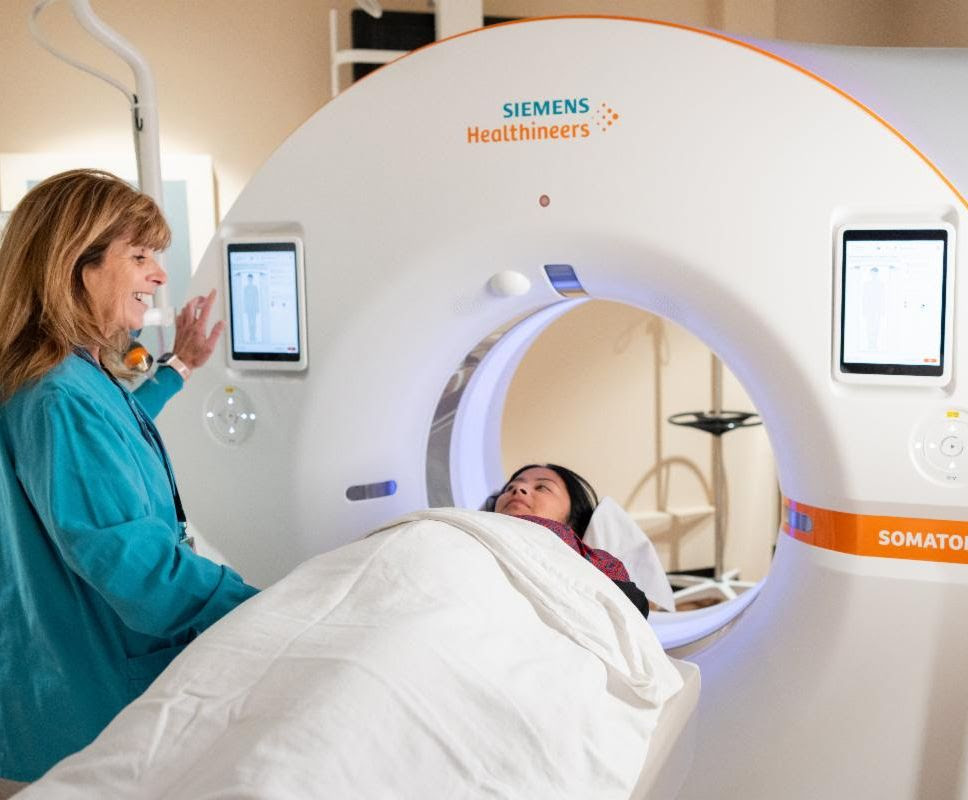 Patient goes through CT scanner