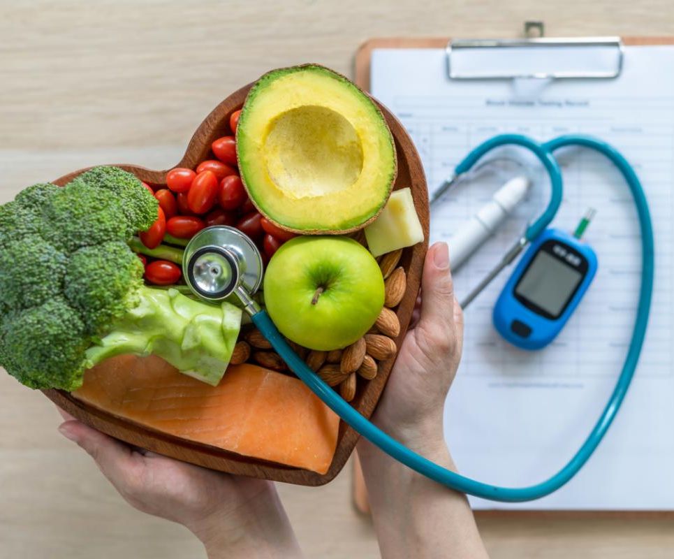 food in shape of heart with stethoscope and blood sugar monitor