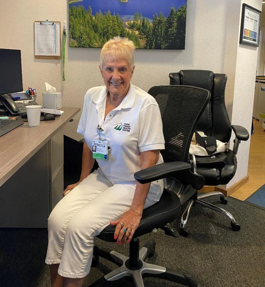 volunteer5 volunteer at hospital sitting behind desk
