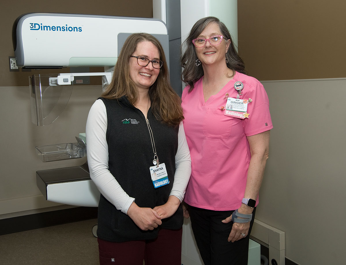 Shayna and Ginger 3D Mammo two healthcare workers standing in front of a mammogram machine