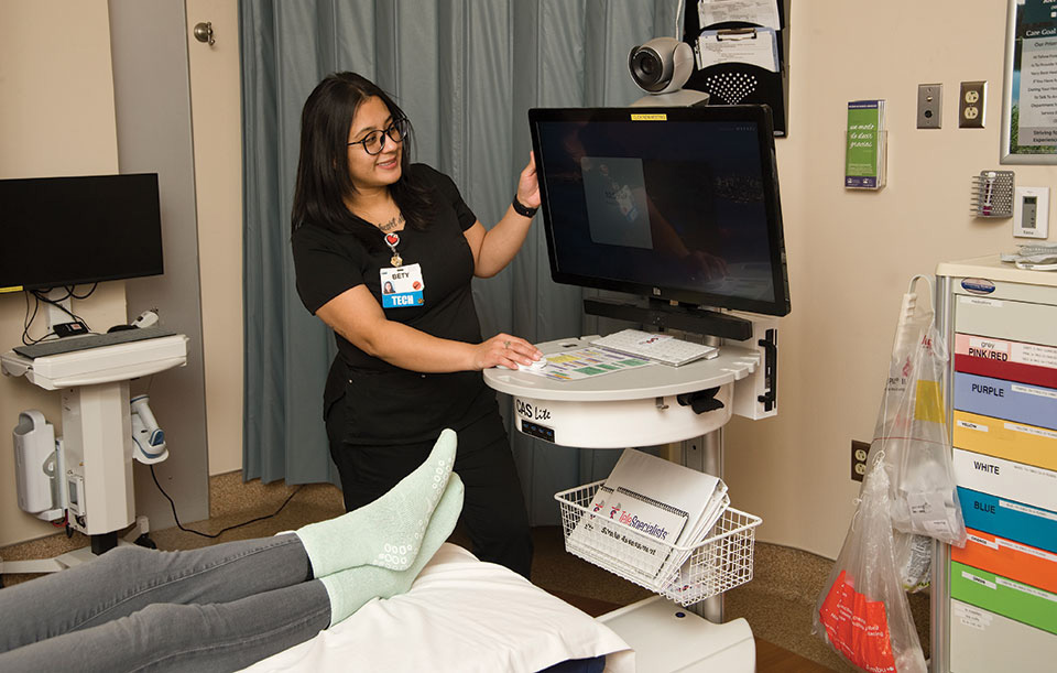 emergency room healthcare worker looking at screen in emergency room