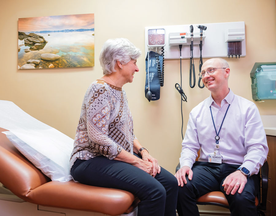 doctor-with-patient-lady doctor talks to patient in exam room