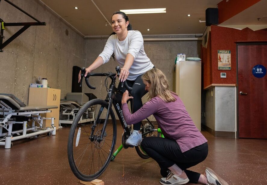 bikefit2 woman sits on bike for a fitting with a specialist