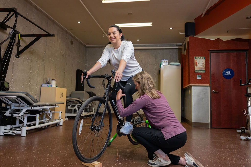 bikefit2 woman sits on bike for a fitting with a specialist