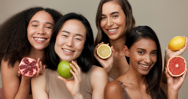 iStock-1832208625 copy diverse group of women each holding a different fruit