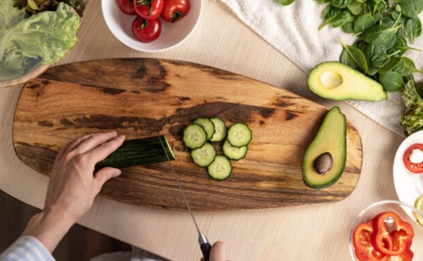 cucumbers hands cut cucumbers, avocado sliced in half