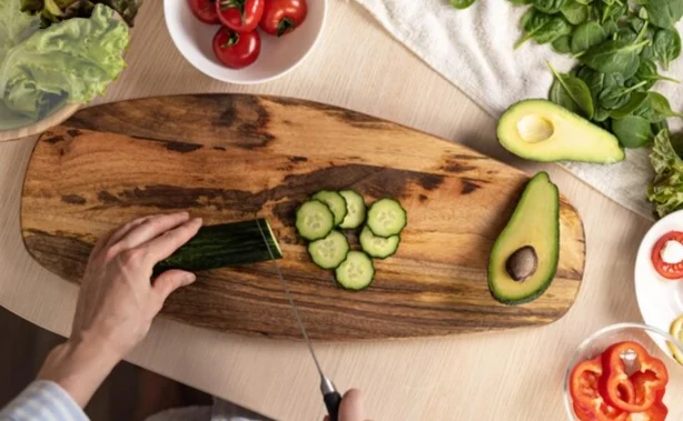 cucumbers hands cut cucumbers, avocado sliced in half