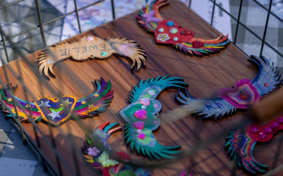 Colorful handmade keepsake ornaments displayed on a table