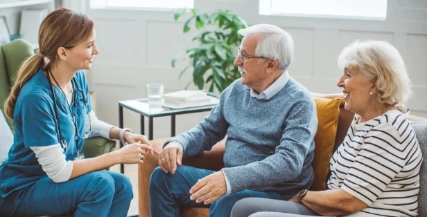 a senior couple speak with a provider