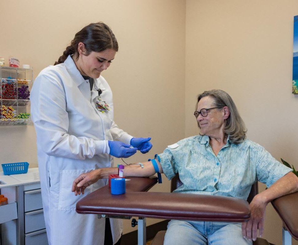 lab provider prepares patient's arm for blood collection
