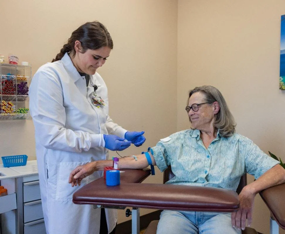 lab provider prepares patient's arm for blood collection